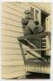 Photograph: [Photograph of Soldier on Barracks Porch]