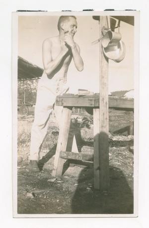 Primary view of object titled '[Photograph of Man Shaving Outside]'.