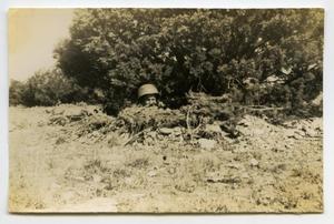 [Photograph of Soldier in Foxhole]