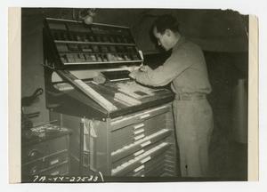 Primary view of object titled '[Photograph of Soldier Working Printing Press]'.