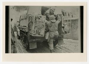 [Photograph of Soldier Climbing into Half-Track]