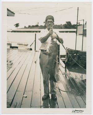 Primary view of object titled '[Henry S. Clountz Holding Catfish]'.