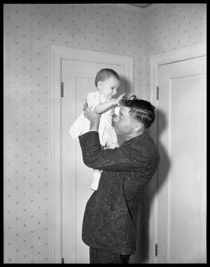 Primary view of object titled '[Man Holding Baby Above Head]'.
