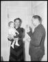 Photograph: [Woman Holding Child Standing with a Man]