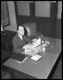 Photograph: [Marvin Hall Sitting at Desk]
