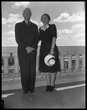 [Man and Woman Standing on Balcony]