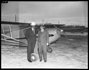 [Two Men Standing with Plane]