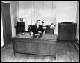 Photograph: [Portrait of man seated at desk at Covert Automobile Co.]