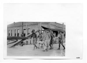 [U.S. Soldiers Carrying a Wounded Man]