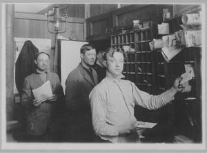 Primary view of object titled '[Photograph of Clerks in Post Office]'.