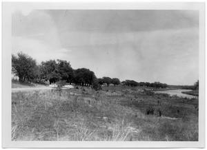 Primary view of object titled '[Car Traveling Down a Dirt Road]'.
