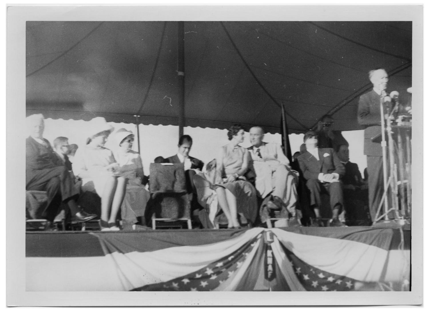 [People Sitting Under a Canopy Behind Konrad Adenauer]
                                                
                                                    [Sequence #]: 1 of 2
                                                