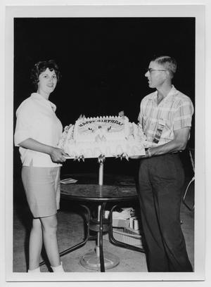 [Two People Holding a Birthday Cake]