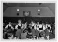 Photograph: [Teenage Girls Dancing in an Auditorium]