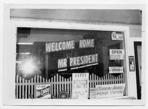 [Storefront with Signage Welcoming the President]