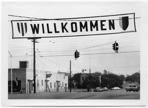 Primary view of object titled '["Willkommen" Banner Over a Street]'.