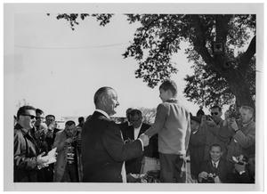Primary view of object titled '[Lyndon Johnson Shaking Hands with a Boy]'.