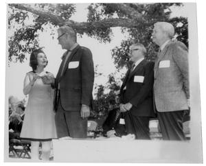 Primary view of object titled '[Lady Bird Johnson Giving a Card to a Man]'.