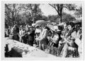 Photograph: [Men and Women Stand by a Picnic Table]