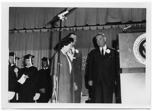 Primary view of object titled '[Lady Bird and Lyndon Johnson on a Stage with Graduates]'.
