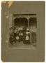 Photograph: [Matthews and Bartholomew Families Sitting Outside on Stairs]