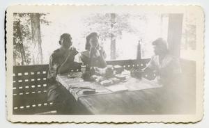 [Photograph of People at Picnic Table]