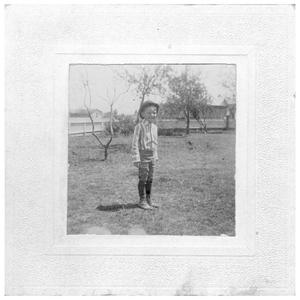 [A Young Boy Standing on a Lawn]