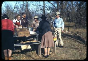 Primary view of object titled '[Men and Women around an Outdoor Picnic Table]'.