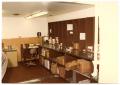 Photograph: [Love Field Interior : Area with Desk and Shelves of Supplies]