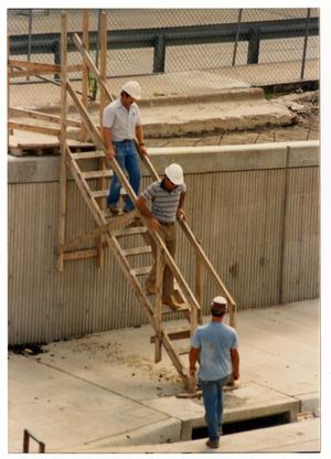 Primary view of object titled '[Dallas Love Field Airport : Three Men Near Construction Site]'.