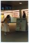 Thumbnail image of item number 1 in: '[Dallas Love Field Airport : Woman Near Shuttle Sign]'.