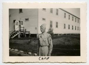 Primary view of object titled '[Photograph of a Soldier near a Cabin]'.