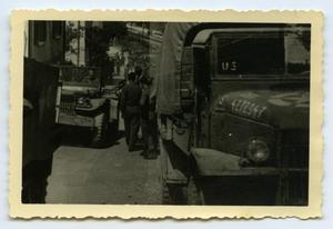 [Photograph of Soldiers and Trucks in Street]