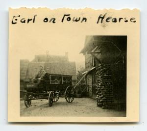 Primary view of object titled '[Earl Palmarier Sitting on the Town Hearse]'.