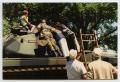 Photograph: [Photograph of a Family around a Tank]