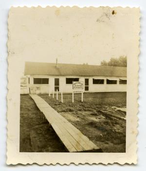 Primary view of object titled '[Photograph of 12th Armored Division Maintenance Battalion Headquarters Building]'.