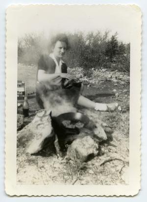 [Photograph of a Lady by a Cooking Fire]