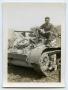 Photograph: [A Soldier Sitting on the Front of a Tank]
