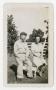 Photograph: [Photograph of a Soldier and a Woman Seated in a Garden]
