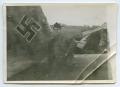 Photograph: [A Soldier Standing Next to a German Airplane]