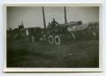 Photograph: [A Soldier Standing on a Large Howitzer]