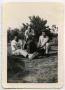 Photograph: [Photograph of Two Soldiers and a Woman with a Black Dog]