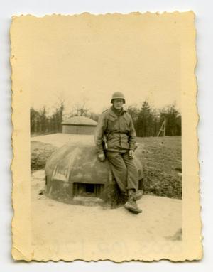 Primary view of object titled '[Photograph of Soldier on Pillbox]'.