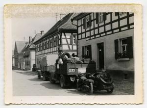 Primary view of object titled '[Three Vehicles Parked on a Sidewalk in Flanders]'.