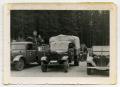 Photograph: [German Soldiers Standing Behind Their Trucks]
