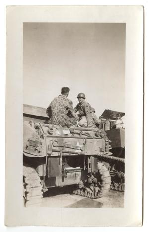 [Two Soldiers Sitting on an Armored Vehicle]