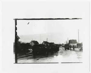 Primary view of object titled '[Army Vehicles and Personnel on a Street]'.