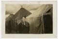 Photograph: [Young Man Near Row of Tents]