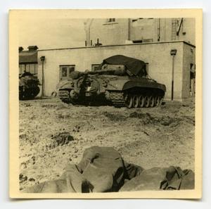 [A Parked Tank Next to a Building]