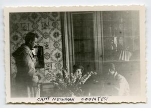[Photograph of Woman and Two Men in Room]